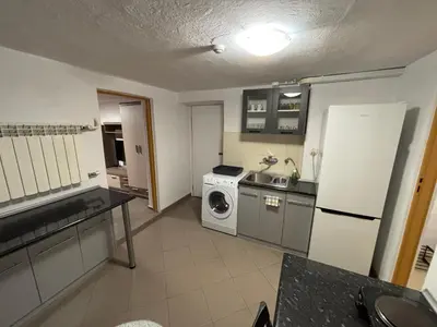 a kitchen with a refrigerator and a washing machine at Nad potokiem in Nowy Targ