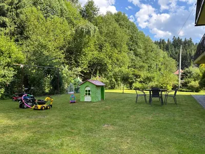 a yard with a play house and a table at Nad potokiem in Nowy Targ