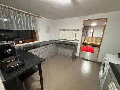 a kitchen with a table and a mirror in it at Nad potokiem in Nowy Targ