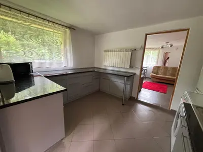 a kitchen with a counter and a window and a couch at Nad potokiem in Nowy Targ
