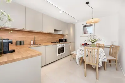 a kitchen with a table and a dining room at Apartament przy Wiśle in Kraków
