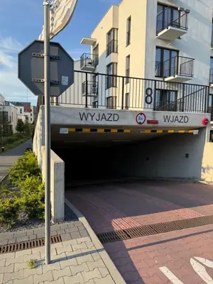 a street sign in front of a building at Zablocie Apartment near to Schindler Fabric - 48m2 in Kraków