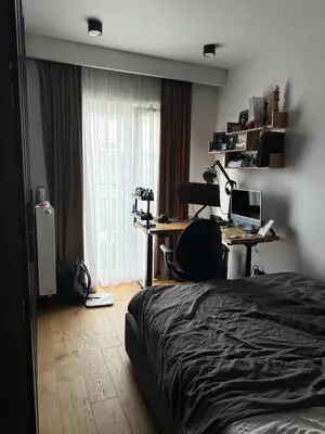 a bedroom with a bed and a desk with a computer at Zablocie Apartment near to Schindler Fabric - 48m2 in Kraków