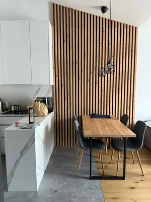 a kitchen with a wooden table and chairs at Zablocie Apartment near to Schindler Fabric - 48m2 in Kraków