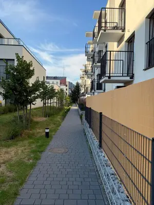an empty sidewalk in a city with buildings at Zablocie Apartment near to Schindler Fabric - 48m2 in Kraków