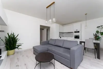 a living room with a couch and a table at Grzegórzki Chic Studio by BookingHost in Kraków