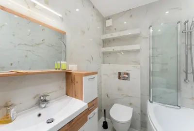a bathroom with a tub and a toilet and a shower at Grzegórzki Chic Studio by BookingHost in Kraków