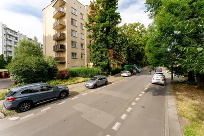 a street with cars parked on the side of the road at Grzegórzki Chic Studio by BookingHost in Kraków