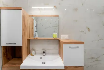 a bathroom with a sink and a mirror at Grzegórzki Chic Studio by BookingHost in Kraków