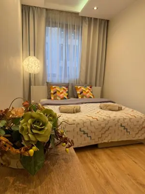 a bedroom with a bed and a couch at Lubicz Apartment 70m2 in Kraków