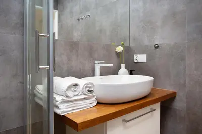 a bathroom with a sink and a glass shower at LORETO 2 by Cozyplace in Kraków
