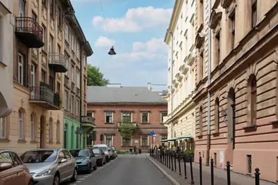 a street with cars parked on the sides of buildings at LORETO 2 by Cozyplace in Kraków
