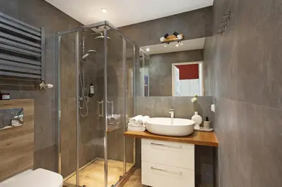 a bathroom with a sink and a shower at LORETO 2 by Cozyplace in Kraków