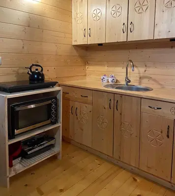 a wooden paneled room with a cross on the wall at Hope Mountain Escape Poland, Wooden Cabin in Szczawa