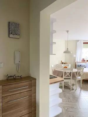 a kitchen and living room with a table and a dining room at Green Garden Oasis in Kraków