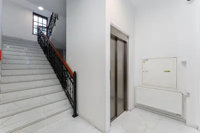 a staircase in a building with a glass door at Limanowskiego Modern Studio by BookingHost in Kraków