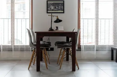 a wooden table with two chairs next to a table at Limanowskiego Modern Studio by BookingHost in Kraków