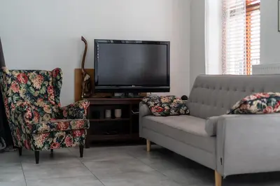 a living room with a couch and a tv at Limanowskiego Modern Studio by BookingHost in Kraków