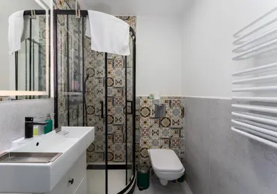 a bathroom with a sink and a toilet and a shower at Limanowskiego Modern Studio by BookingHost in Kraków