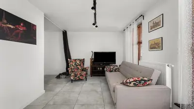 a living room with a couch and a tv at Limanowskiego Modern Studio by BookingHost in Kraków