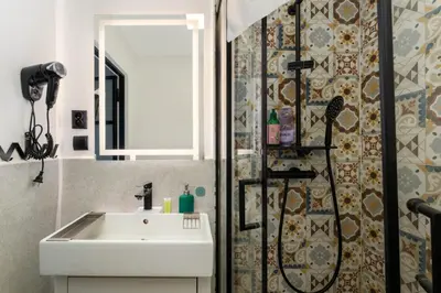 a bathroom with a sink and a shower at Limanowskiego Modern Studio by BookingHost in Kraków