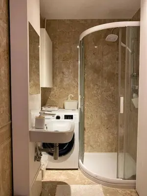 a bathroom with a sink and a shower at Comfortable and large apartment in Kraków