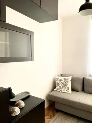 a living room with a couch and a table at Comfortable and large apartment in Kraków