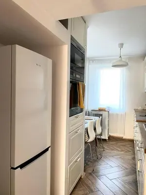 a kitchen with a white refrigerator and a table at Comfortable and large apartment in Kraków