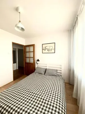 a bedroom with a black and white checkered bed at Comfortable and large apartment in Kraków