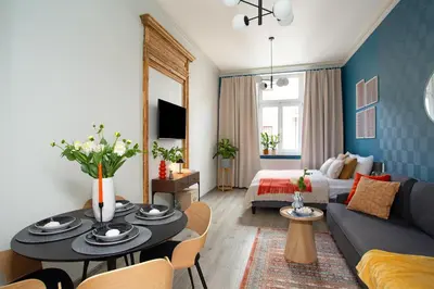 a living room with a couch and a table at LORETO 3 by Cozyplace in Kraków