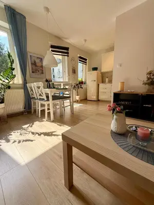 a living room with a table and a dining room at Kraków Nest in Kraków