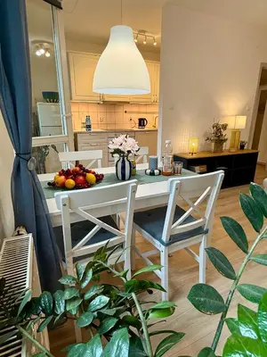 a kitchen with a table and chairs with fruit on it at Kraków Nest in Kraków