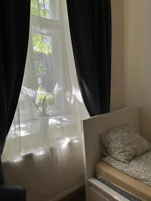 a bedroom with a bed and a dresser at Apartament Peonia in Kraków