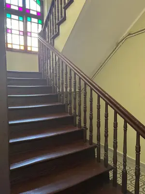 a stairway with a stained glass window at Apartament Peonia in Kraków