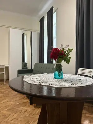 a white table with two chairs and a book on it at Apartament Peonia in Kraków