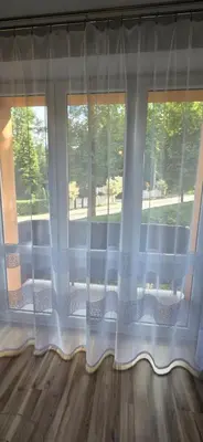 a window with white curtains in a room at W Rabczańskiej Dolinie in Rabka