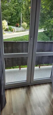 an open sliding glass door with a bench outside at W Rabczańskiej Dolinie in Rabka