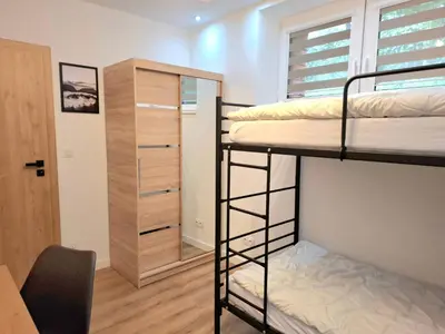 a dorm room with two bunk beds and a desk at sPokoje in Wieliczka