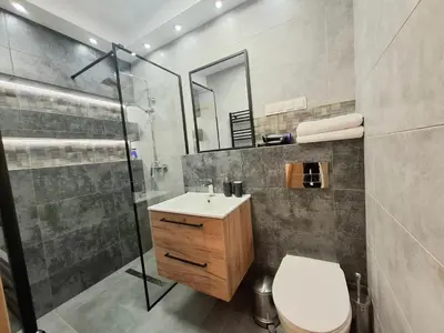 a bathroom with a toilet and a shower and a sink at sPokoje in Wieliczka
