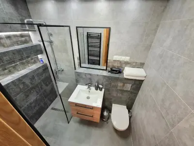 a bathroom with a sink and a shower and a toilet at sPokoje in Wieliczka