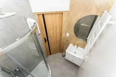 a bathroom with a sink and a mirror at Kazimierz Comfort Apartment- Starowiślna 54 in Kraków
