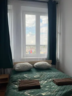 a bedroom with a bed with a large window at TOM PRIVATE room in Kraków