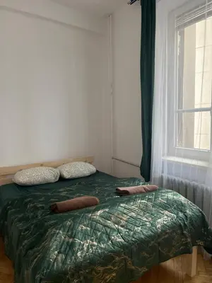 a bedroom with a bed with two pillows and a window at TOM PRIVATE room in Kraków