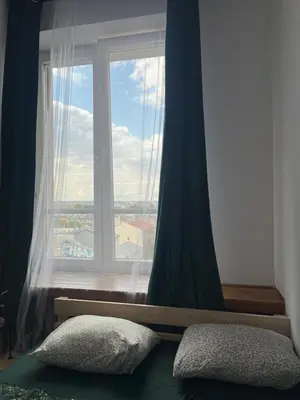 a window in a bedroom with a pillow in front of it at TOM PRIVATE room in Kraków
