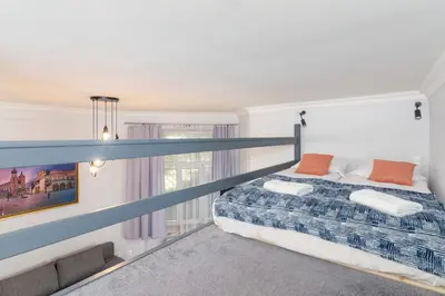 a bedroom with a bed and a large window at Świętego Filipa Apartments Cracow by Noclegi Renters in Kraków