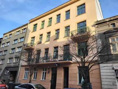 a yellow building with balconies on the side of it at Świętego Filipa Apartments Cracow by Noclegi Renters in Kraków