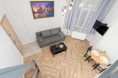 an overhead view of a living room with a couch and a table at Świętego Filipa Apartments Cracow by Noclegi Renters in Kraków