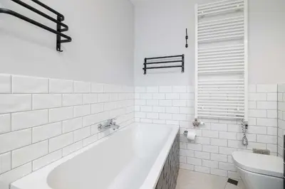 a white bathroom with a tub and a sink at Air Conditioned Apartment in Cracow with Parking, Desk and Bathtub by Noclegi Renters in Kraków