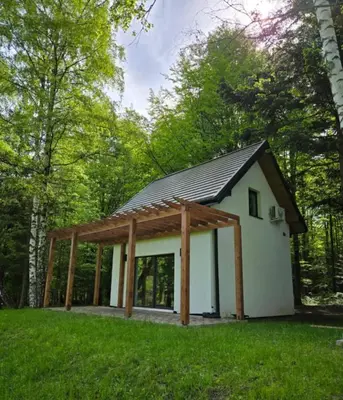 a small white house with a pitched roof at Fundacja Dom Pracy Twórczej PAU Zawoja in Zawoja