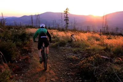 a person riding a bike down a dirt trail at Fundacja Dom Pracy Twórczej PAU Zawoja in Zawoja